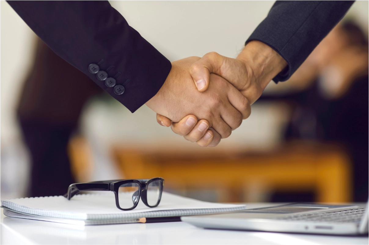 Two hands, holding each other for making a deal.
